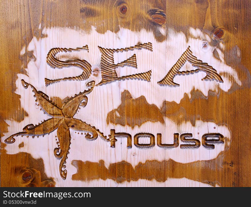 Wood carving with jellyfish and caption sea house