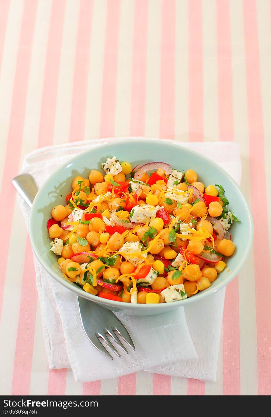 Vegetarian meal of chickpea with red peppers, radish, corn, onion and feta cheese. Vegetarian meal of chickpea with red peppers, radish, corn, onion and feta cheese