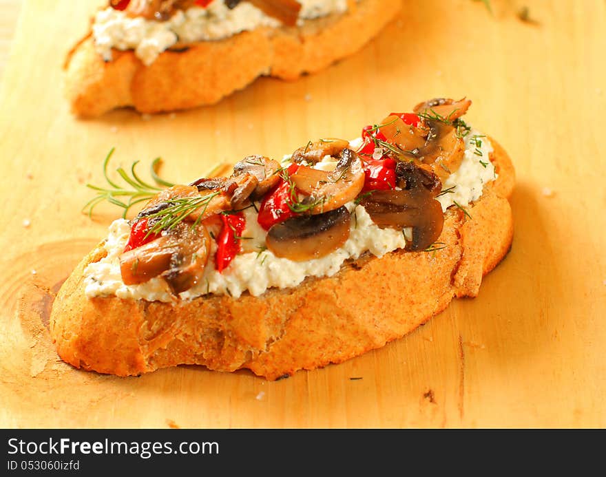 Fresh homemade crispy Italian appetizer with cream cheese, mushrooms and red peppers. Selective focus. Fresh homemade crispy Italian appetizer with cream cheese, mushrooms and red peppers. Selective focus.