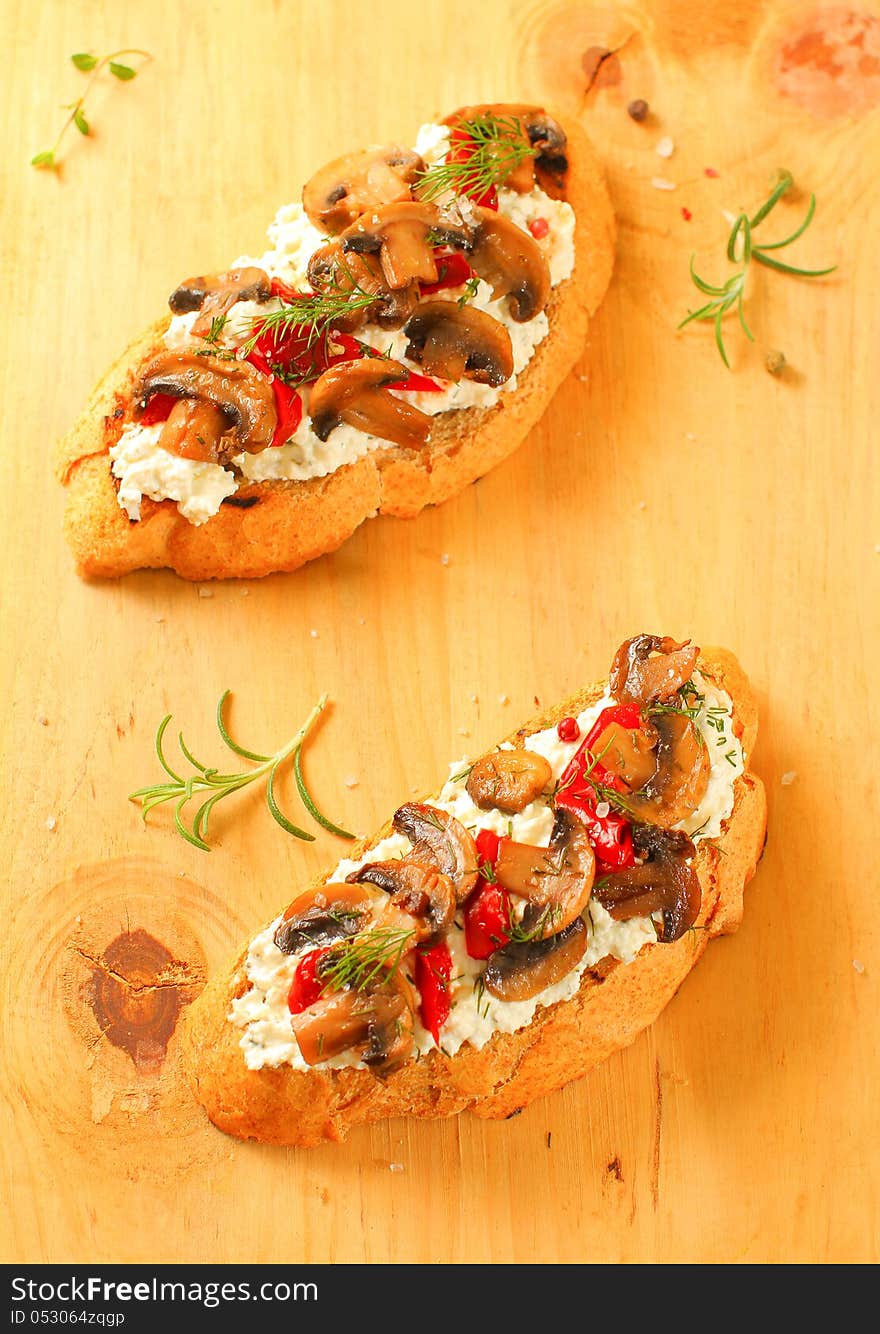 Fresh homemade crispy Italian appetizer with cream cheese, mushrooms and red peppers. Selective focus. Fresh homemade crispy Italian appetizer with cream cheese, mushrooms and red peppers. Selective focus.