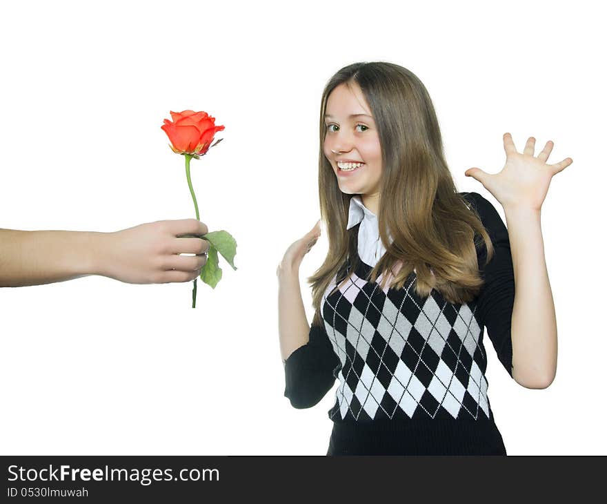 Teen girl  rejoice in red rose, isolated on white