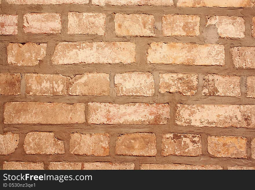 Old gray brick wall as background closeup