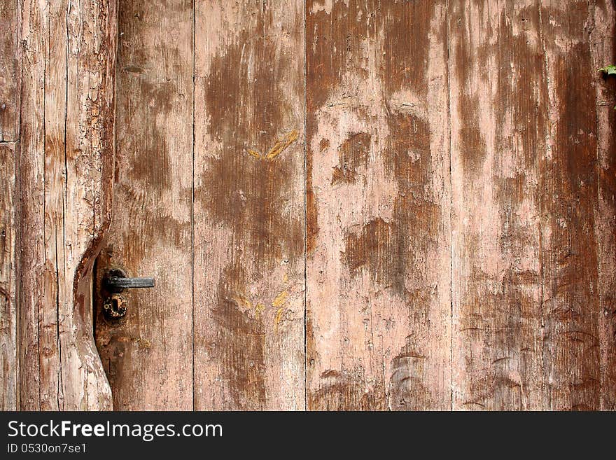 Old brown wooden door with metal latch as antique background. Old brown wooden door with metal latch as antique background