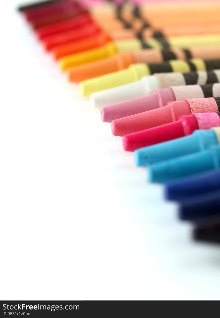 Beautiful colorful pastel(crayon) pencils in a row(line) on white background with copy space for text. Beautiful colorful pastel(crayon) pencils in a row(line) on white background with copy space for text