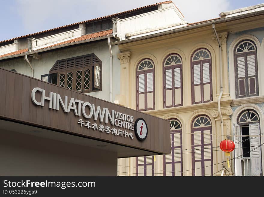 Chinatown visitor centre in Singapore with traditional houses and red lantern behind. Chinatown visitor centre in Singapore with traditional houses and red lantern behind