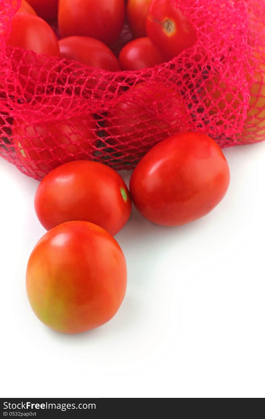 Fresh juicy organic tomatoes on white background. The fruits are ripe and bright red in color and ready for consumption