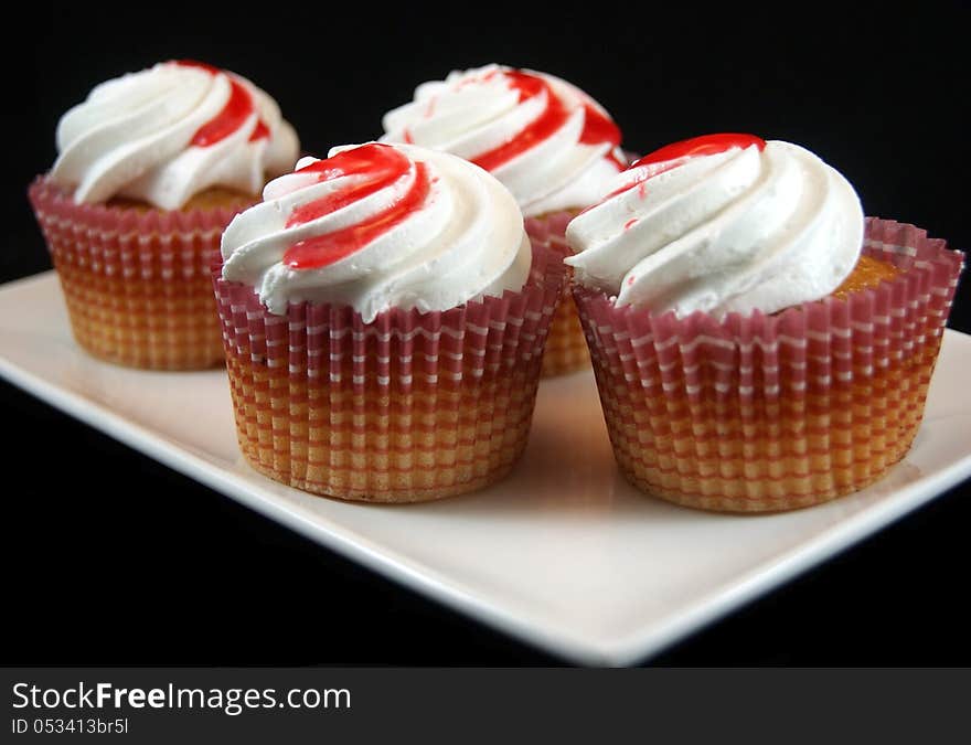 Homemade cupcakes with cream and strawberry jam