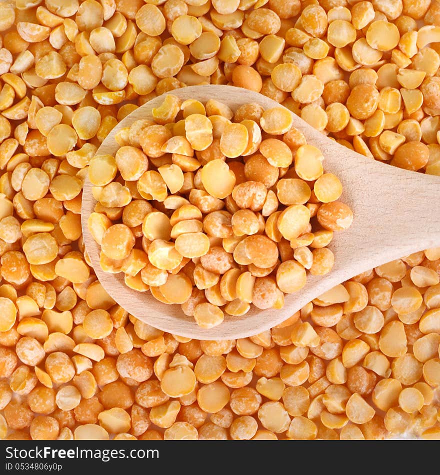 Dry peas in a wooden spoon, macro. Dry peas in a wooden spoon, macro