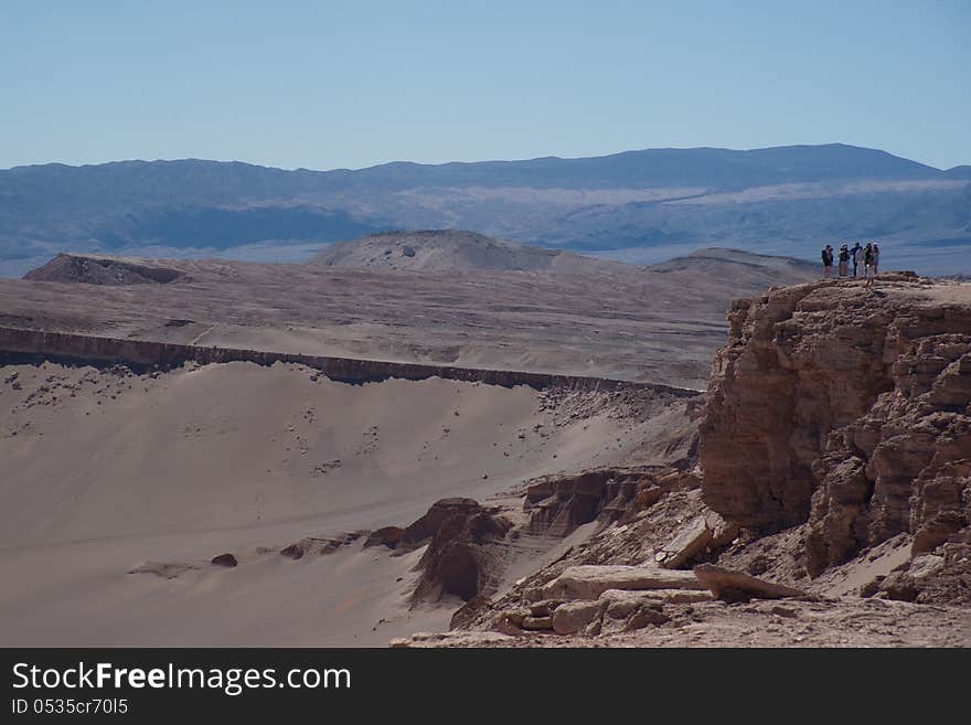 People standing on a viewing spot in the Atacama Desert. People standing on a viewing spot in the Atacama Desert.