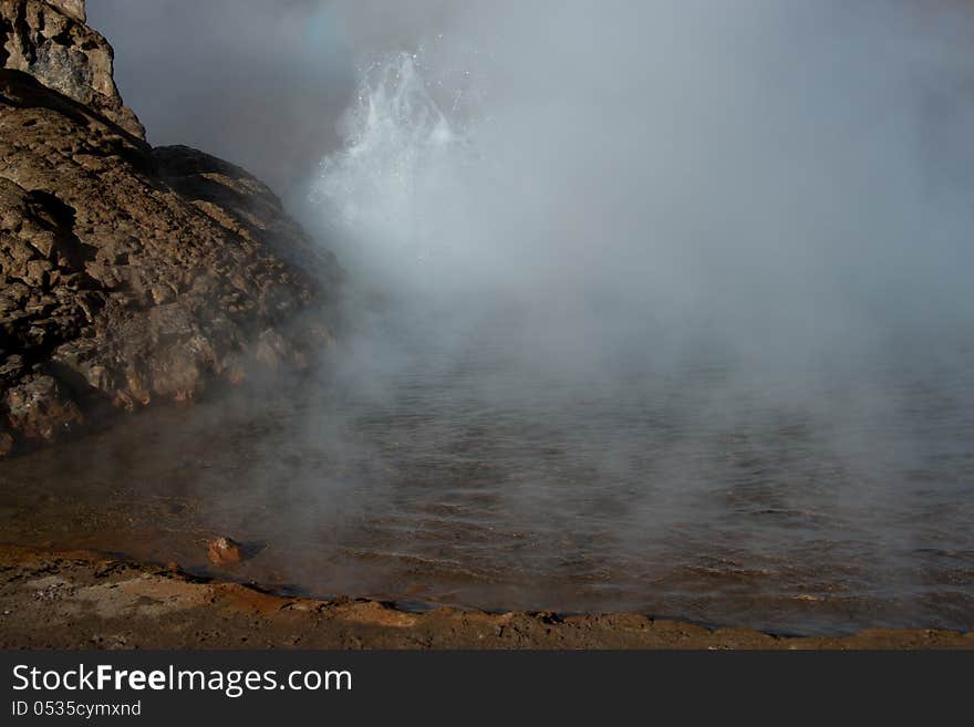 A geyser erupting at Tatio Geysers. A geyser erupting at Tatio Geysers