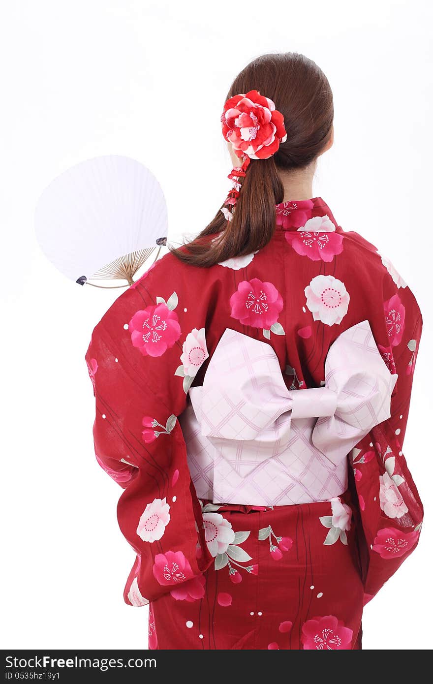 Rear view of asian woman in traditional clothes of kimono with paper fan. Rear view of asian woman in traditional clothes of kimono with paper fan