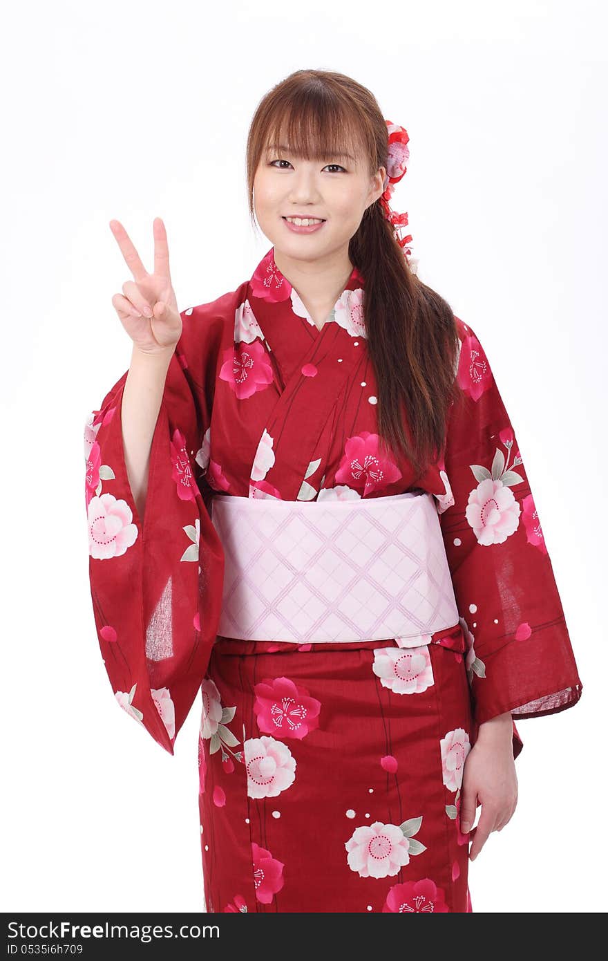 Young asian woman in traditional clothes of kimono with peace sign. Young asian woman in traditional clothes of kimono with peace sign