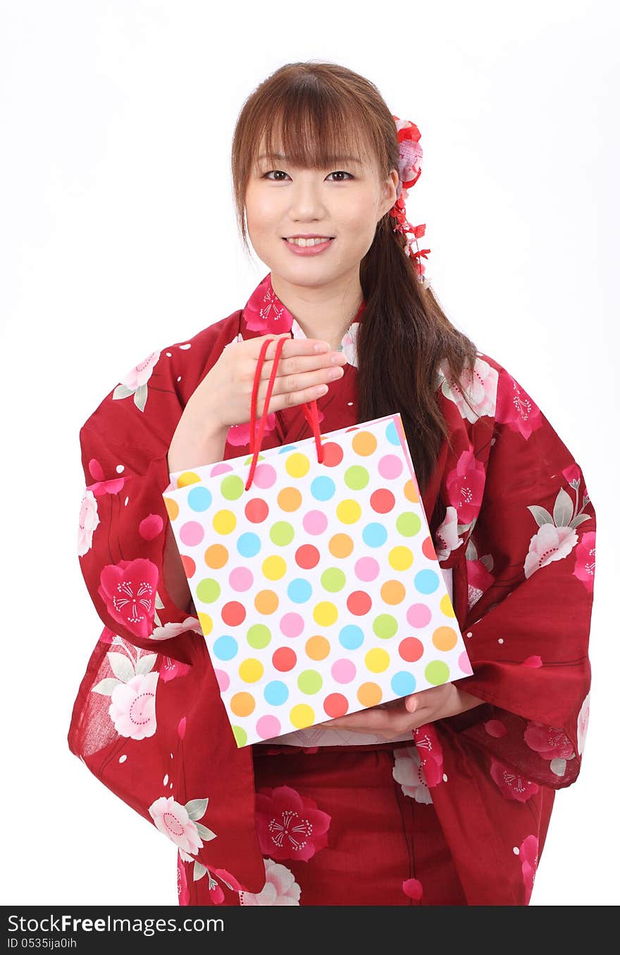 Young asian woman in traditional clothes of kimono with shopping bags. Young asian woman in traditional clothes of kimono with shopping bags