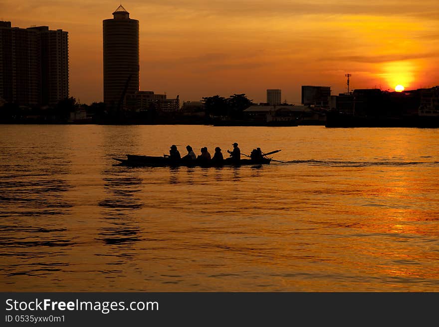 Small ferry boat, Chao Phraya River at sunset, Bangkok, Thailand