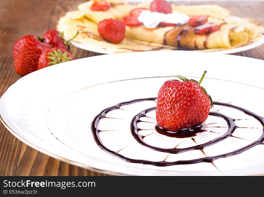 Pancakes with fresh strawberries and chocolate