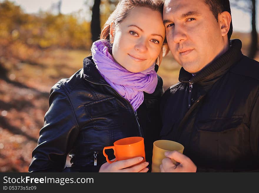 Young family drinking coffee outdoors