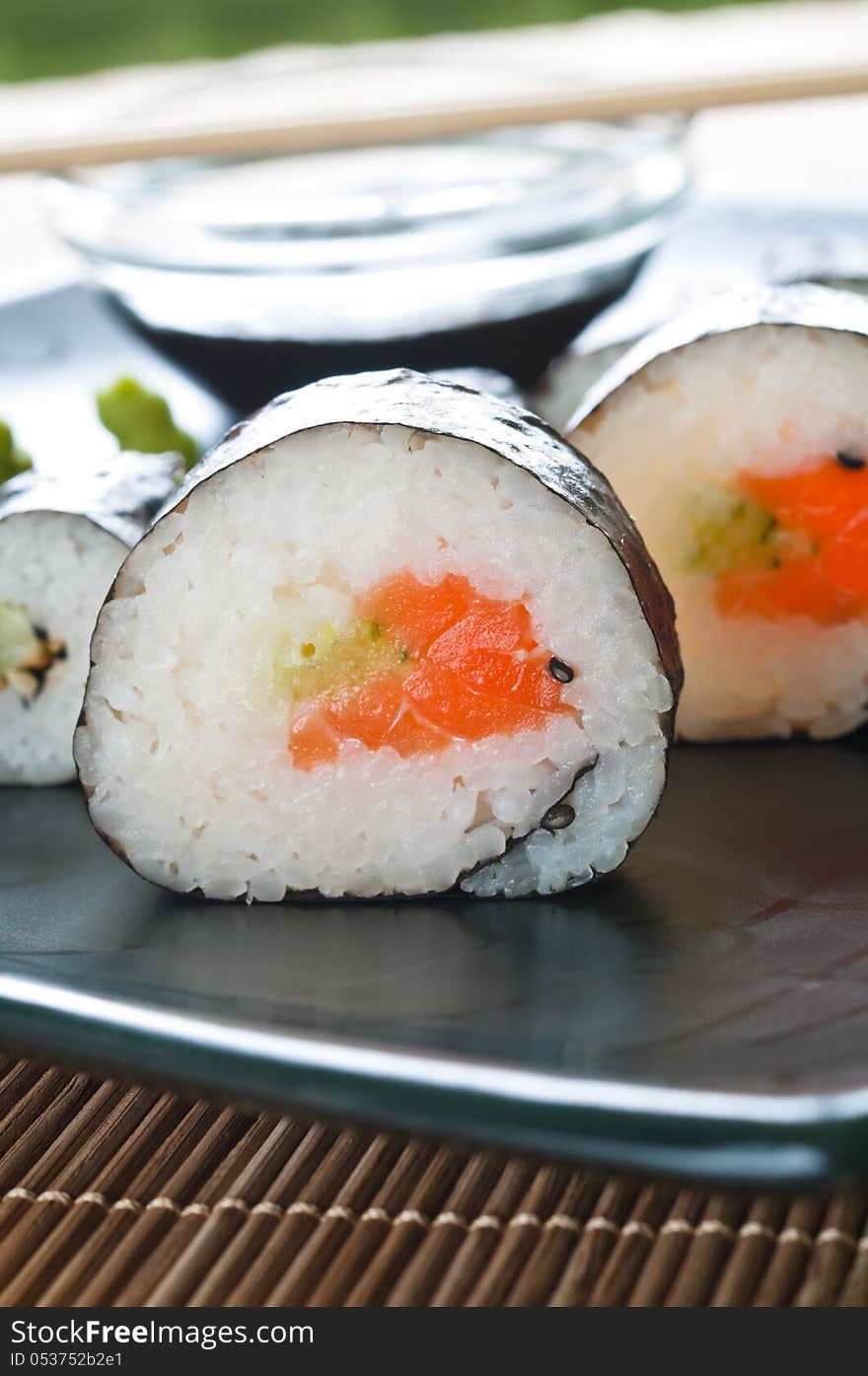 Selection of Japanese sushi arranged on black plate