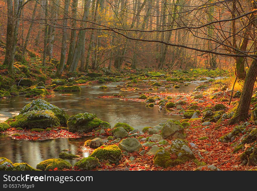 Beautiful autumn foliage, waterfalls and reflection patterns in mountain stream in the forest. Beautiful autumn foliage, waterfalls and reflection patterns in mountain stream in the forest