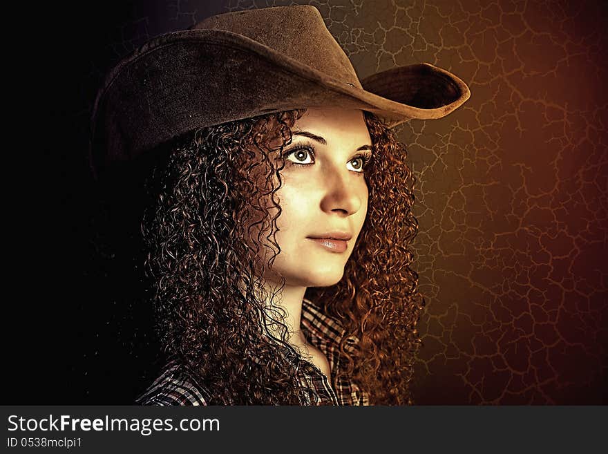 Portrait of pretty curly girl cowboy