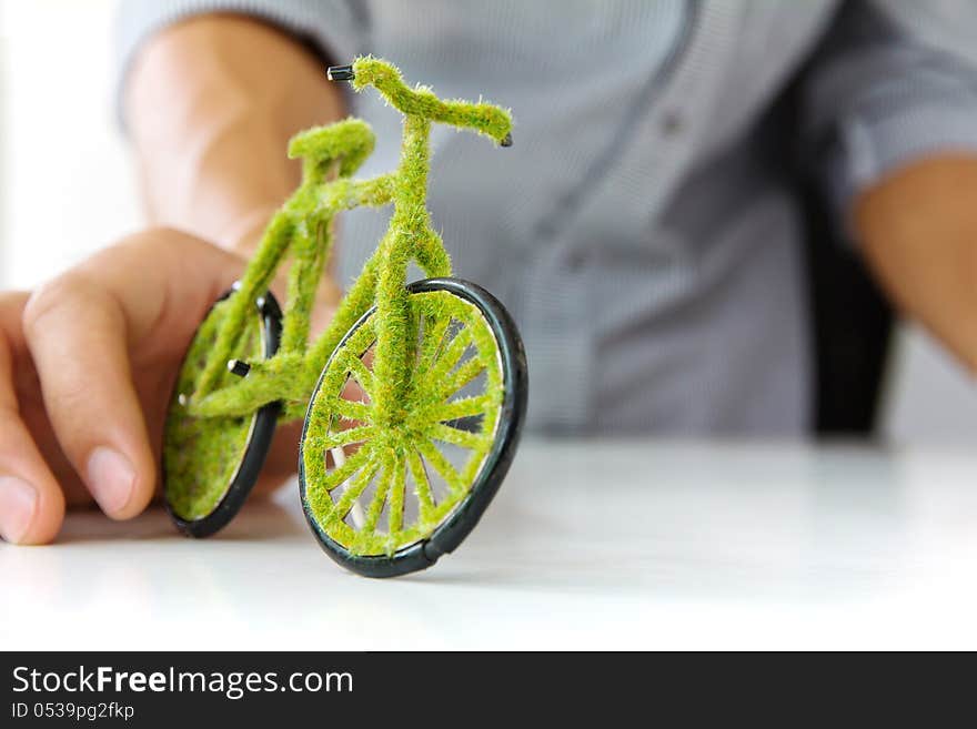 Hand holding eco bicycle concept