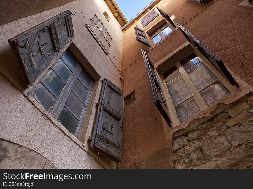 Two orange plastered walls in an angle covered with shutters, shot from a low angle. Two orange plastered walls in an angle covered with shutters, shot from a low angle.