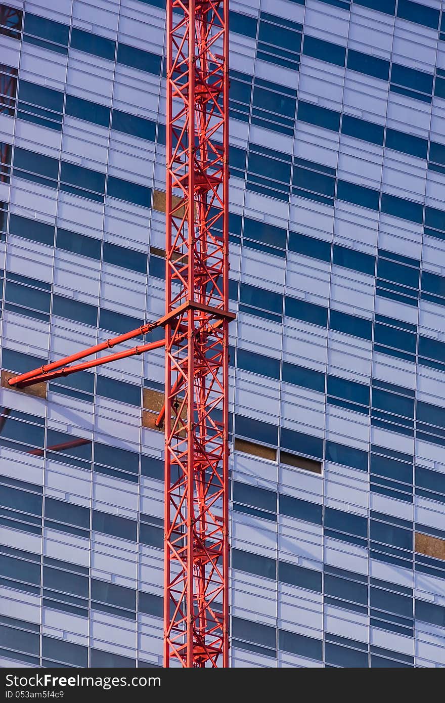 Vertical view of the crane attached to the skyscrapper under construction in the Warsaw downtown, Poland