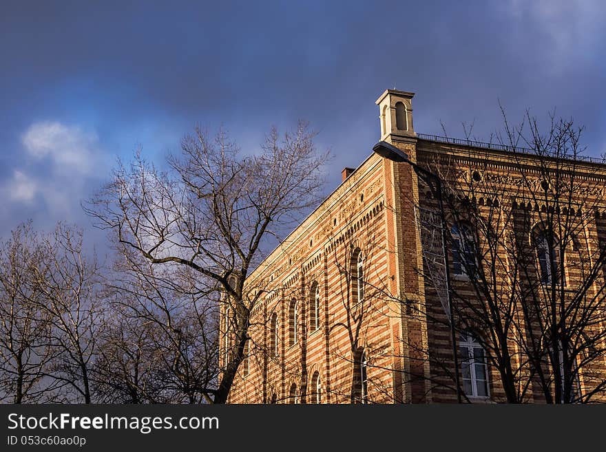 Sun-drenched tenement at the cloudy sky in Gliwice, Silesia region, Poland