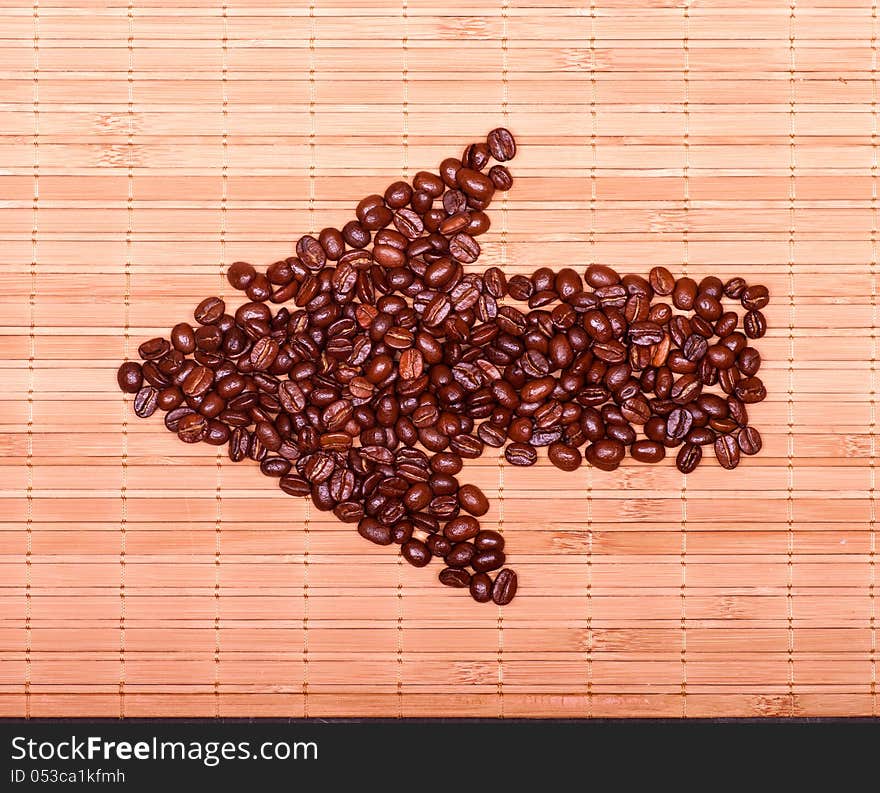 Arrow of coffee beans on a decorative straw