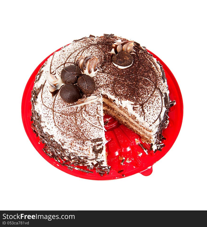 Cake chocolate on red plate on a white background