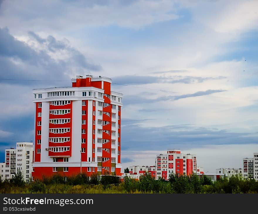 Buildings In A City In An Environment Of Green Trees. Buildings In A City In An Environment Of Green Trees