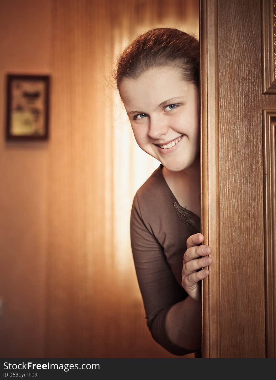 Beautiful Girl Peeking Behind The Door. Beautiful Girl Peeking Behind The Door