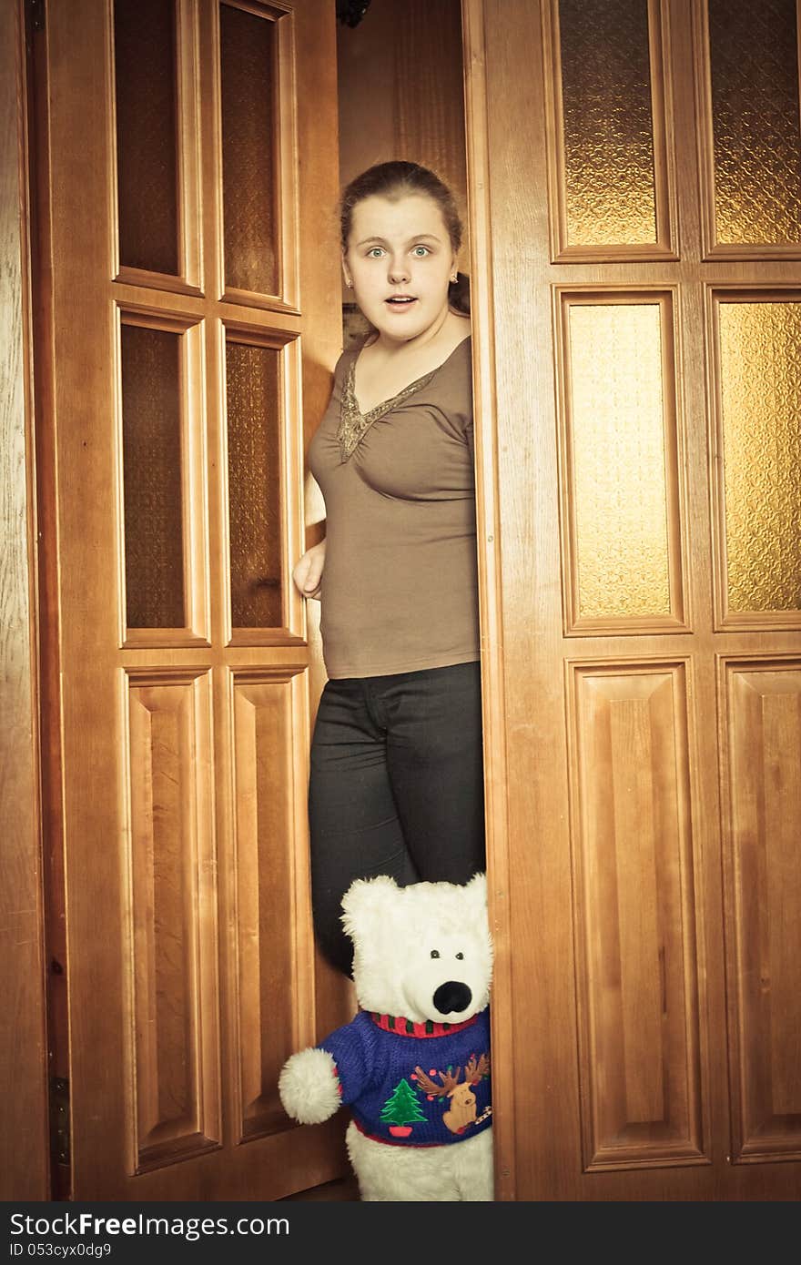 Beautiful Girl And Your Toy Bear Peeking Behind The Door. Beautiful Girl And Your Toy Bear Peeking Behind The Door