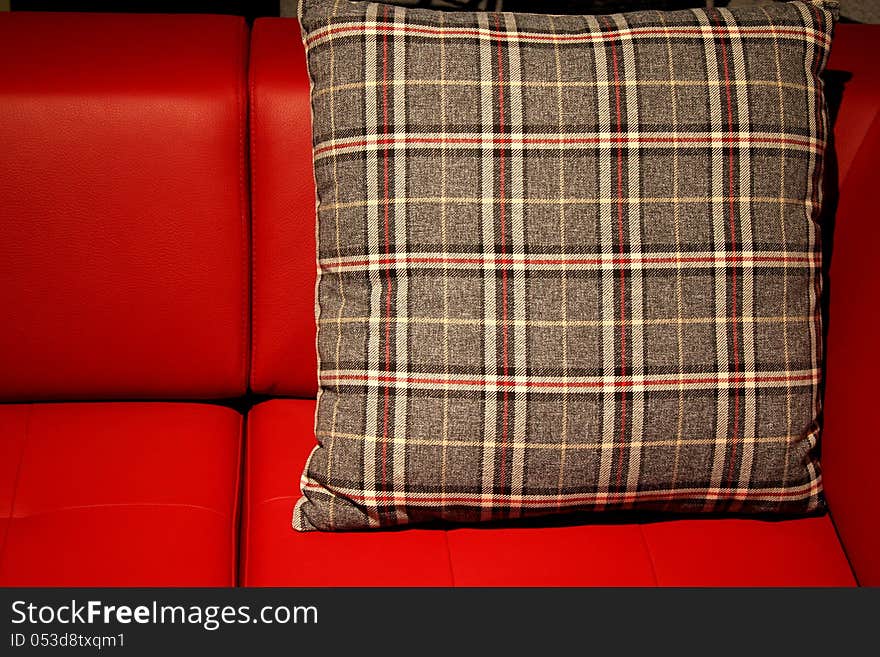 Red sofa and brown decorative pillow. Red sofa and brown decorative pillow