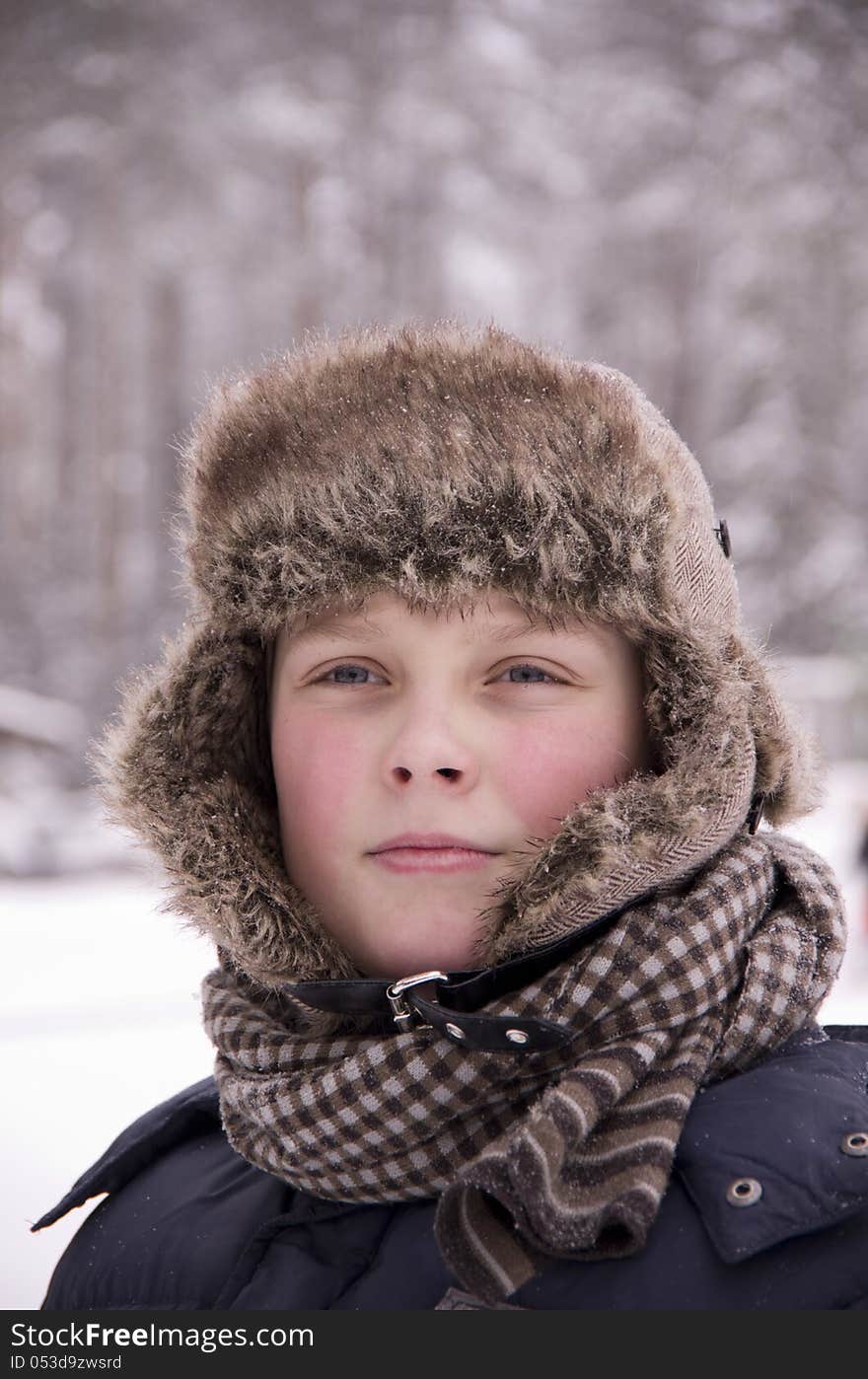 Winter portrait of a teenager in the forest