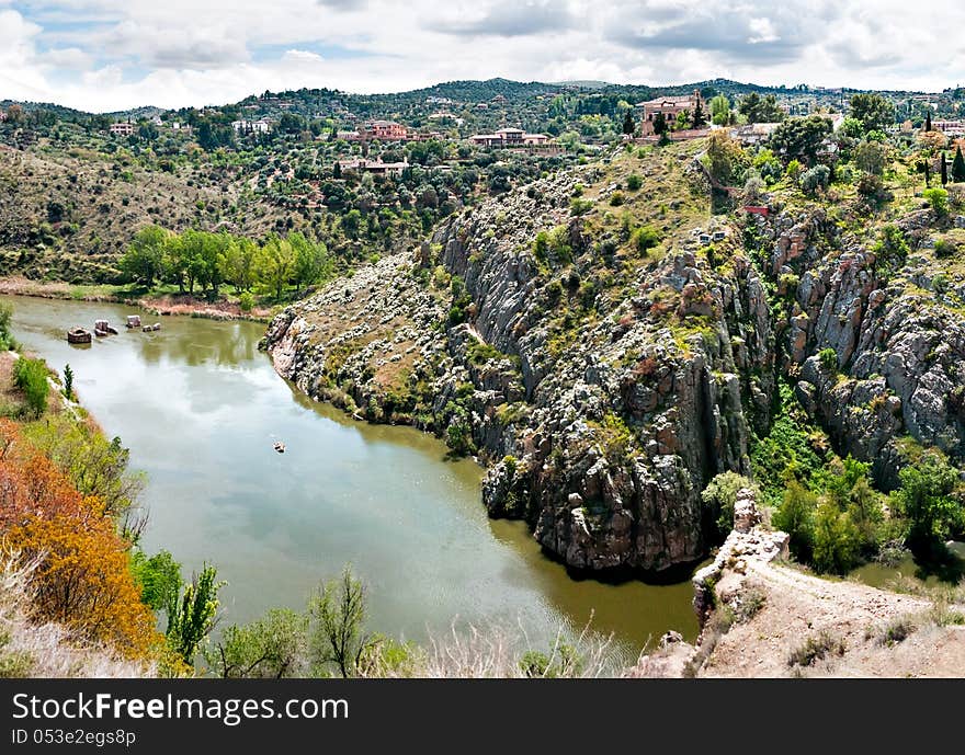 Typical castilian landscape and the Tagus River, the longest river on the Iberian Peninsula at 1,038 kilometers, begins its journey in the Albarracin mountains in Spain, and follows very constricted course for much of its length before reaching the Atlantic Ocean in Portugal. Seen here, it passes through the World Heritage listed city of Toledo. Typical castilian landscape and the Tagus River, the longest river on the Iberian Peninsula at 1,038 kilometers, begins its journey in the Albarracin mountains in Spain, and follows very constricted course for much of its length before reaching the Atlantic Ocean in Portugal. Seen here, it passes through the World Heritage listed city of Toledo.