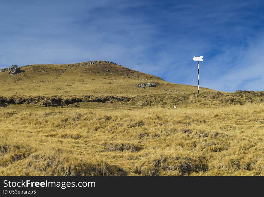 Direction sign for hikers on mountain path