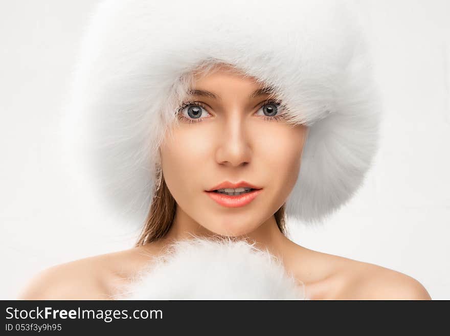 Fashion portrait of young beautiful woman posing on white background