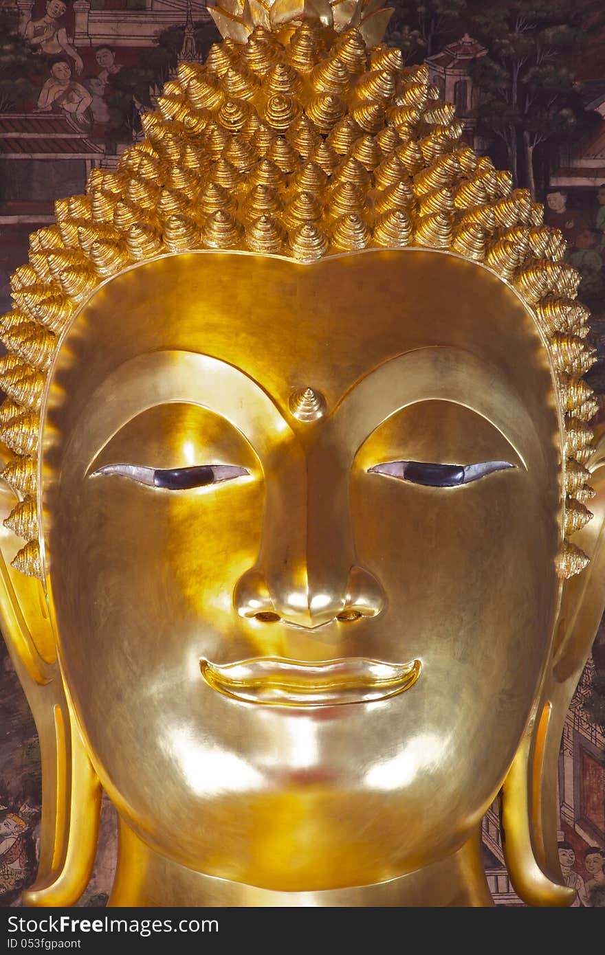 Golden Buddha face in Bangkok Thailand showing calm and mercy.