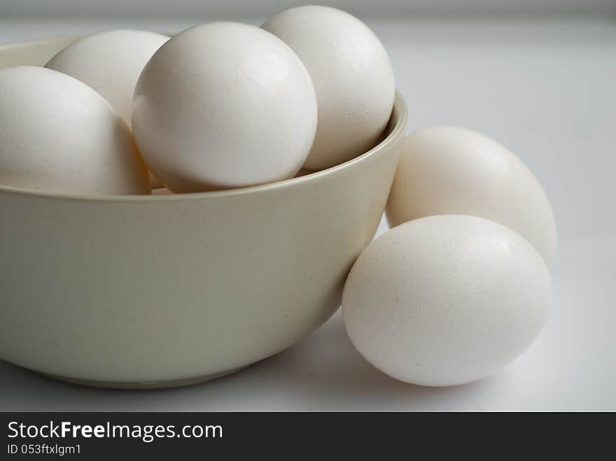 A bowl of eggs on white background