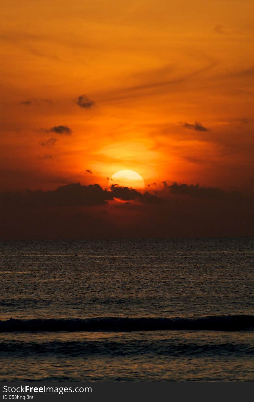 Red Sunset on Indian Ocean over Breaking Waves