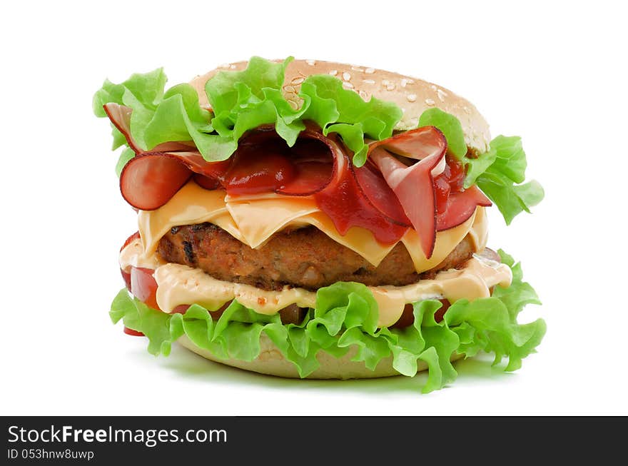 Delicious Hamburger with Bacon, Beef, Cheese, Tomato, Mayonnaise and Lettuce isolated on white background