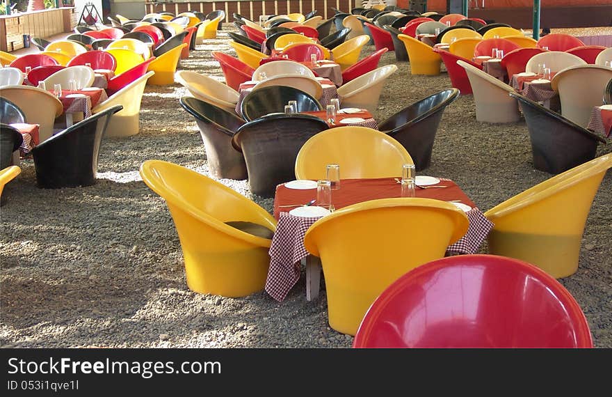 Colourful Tables and chairs arranged for outdoor service. Colourful Tables and chairs arranged for outdoor service