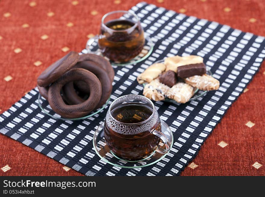 Two cups of tea with two plates with cookies studio shot