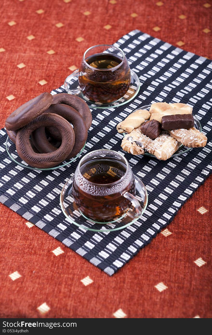 Two cups of tea with two plates with cookies studio shot