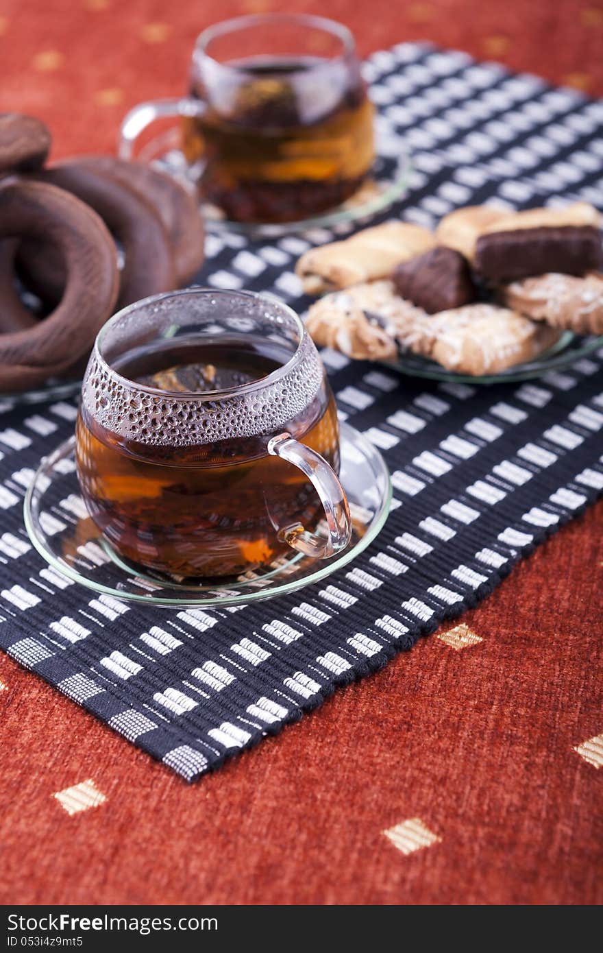 Two cups of tea with two plates with cookies studio shot