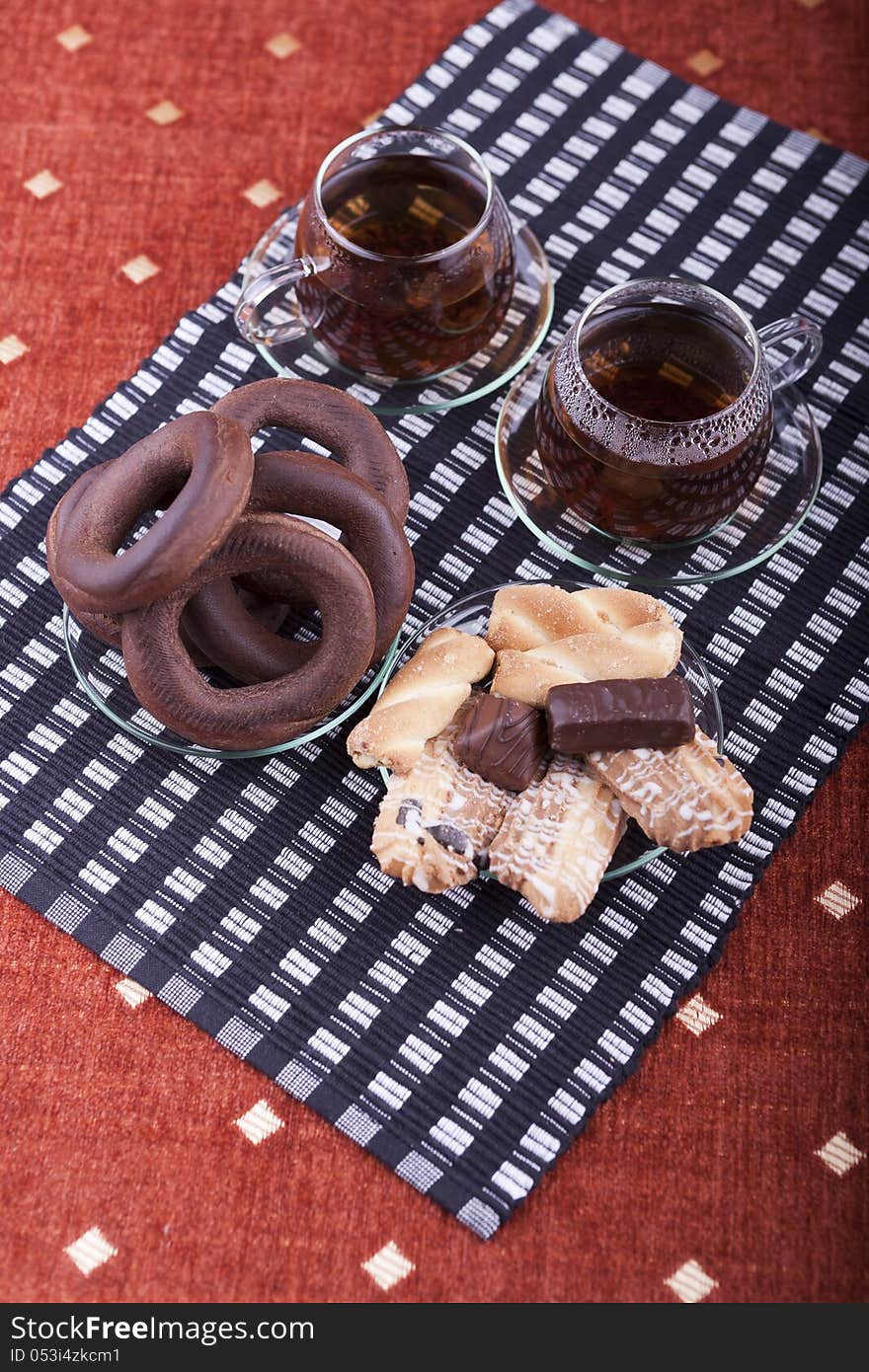 Two cups of tea with two plates with cookies studio shot