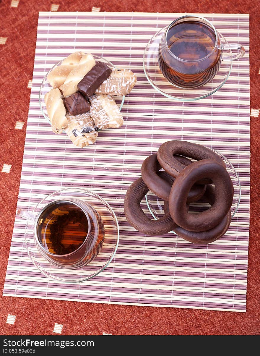 Two cups of tea with two plates with cookies studio shot