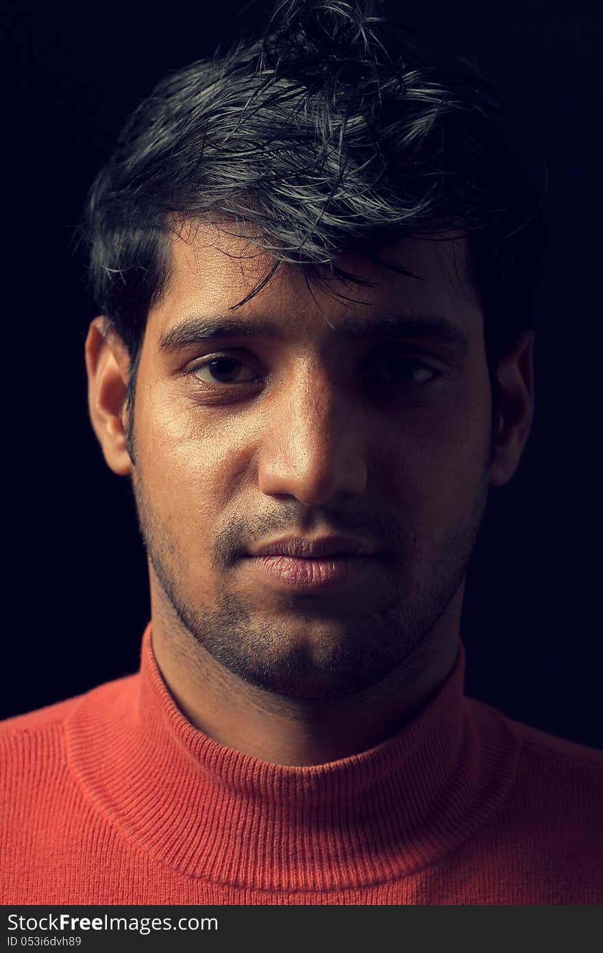 Portrait of young Indian  man over dark