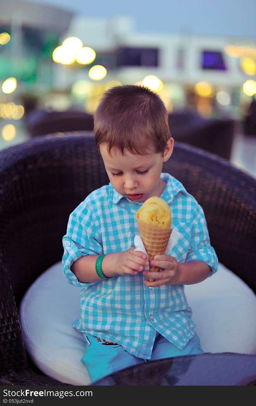 Against the evening of boy eating ice cream. Against the evening of boy eating ice cream