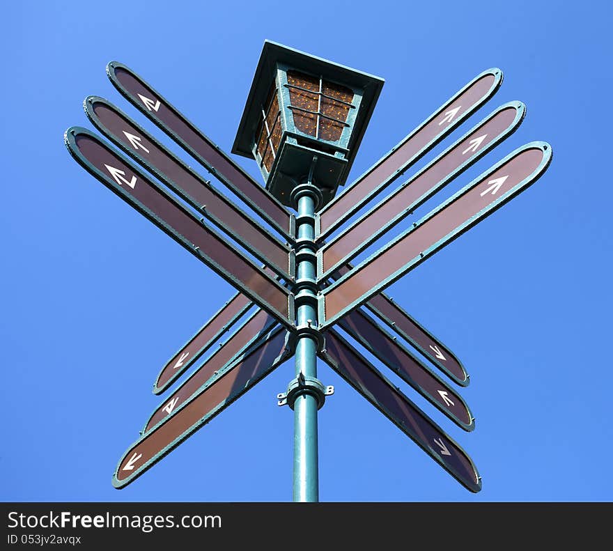 Blank directional road signs over blue sky